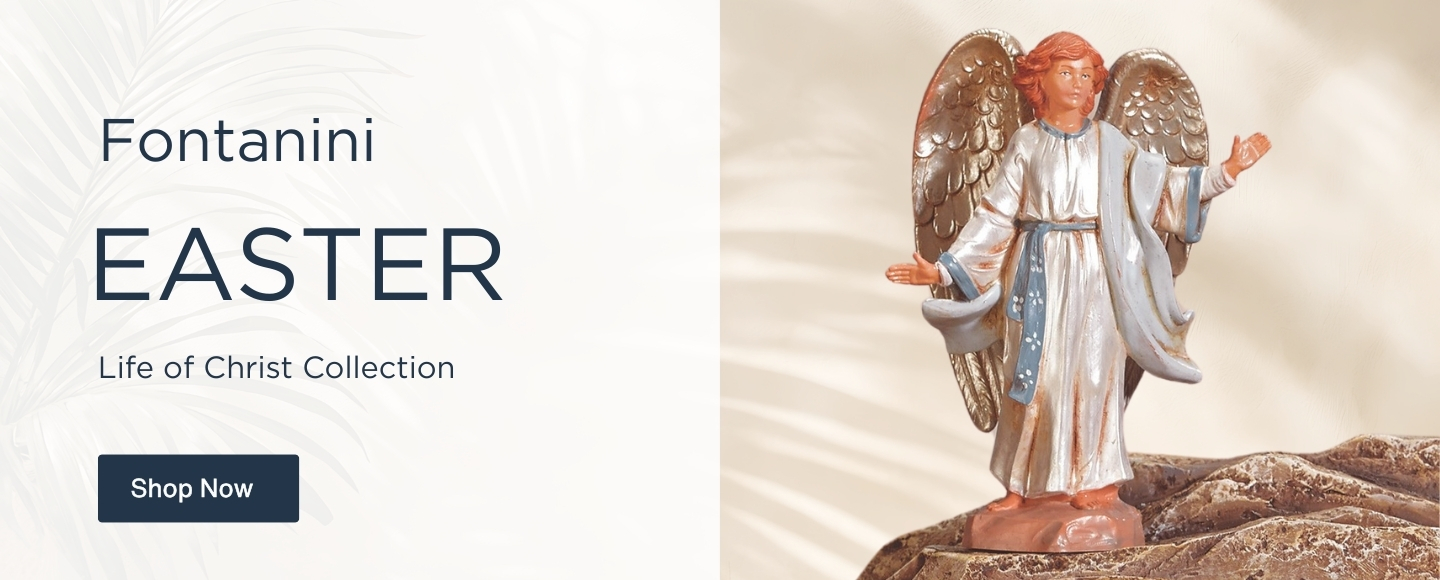 Fontanini Angel at Resurrection with metallic wings standing on top of brown, rocky tomb, with beige, leafy background.